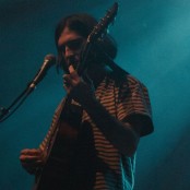 Artist Mountain Boy on stage with a guitar